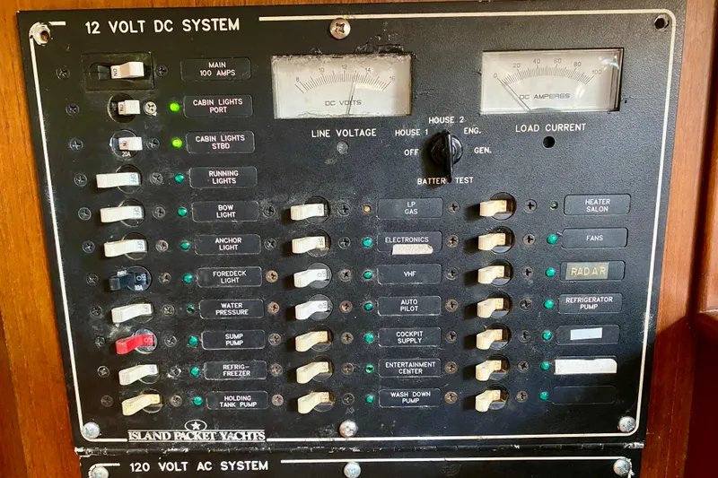 Slide: The Image of Electrical panel of a 1994 Island Packet 44 yacht, showing 12-volt DC system controls. - 124