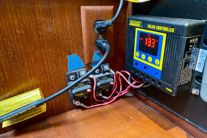 Slide: The Image of Solar controller setup on 1994 Island Packet 44 yacht, displaying voltage. - 127
