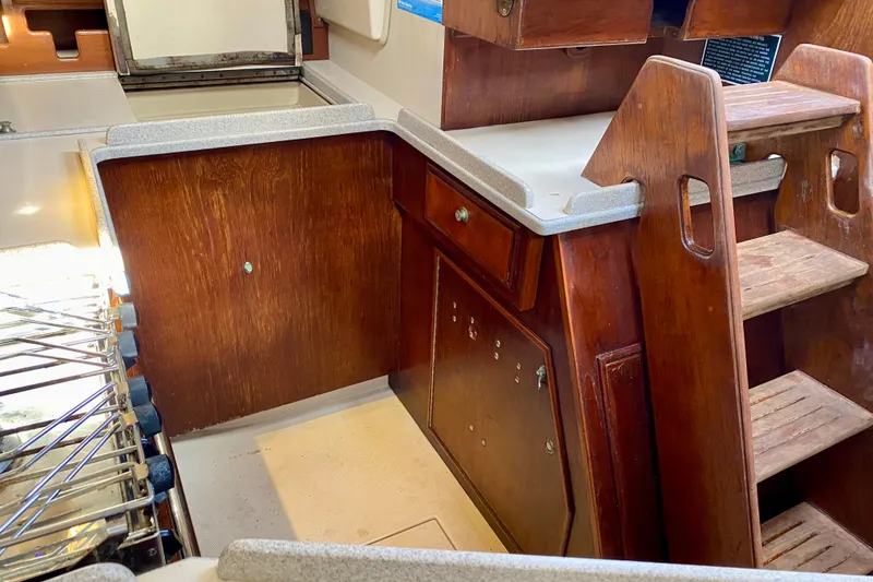 Slide: The Image of Interior of 1994 Island Packet 44 sailboat with wooden cabinetry and steps. - 129