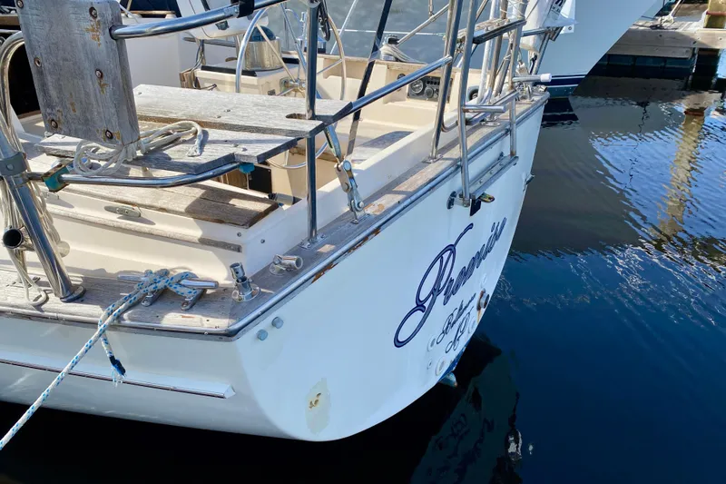 Slide: The Image of Stern view of 1994 Island Packet 44 sailboat docked in marina. - 14