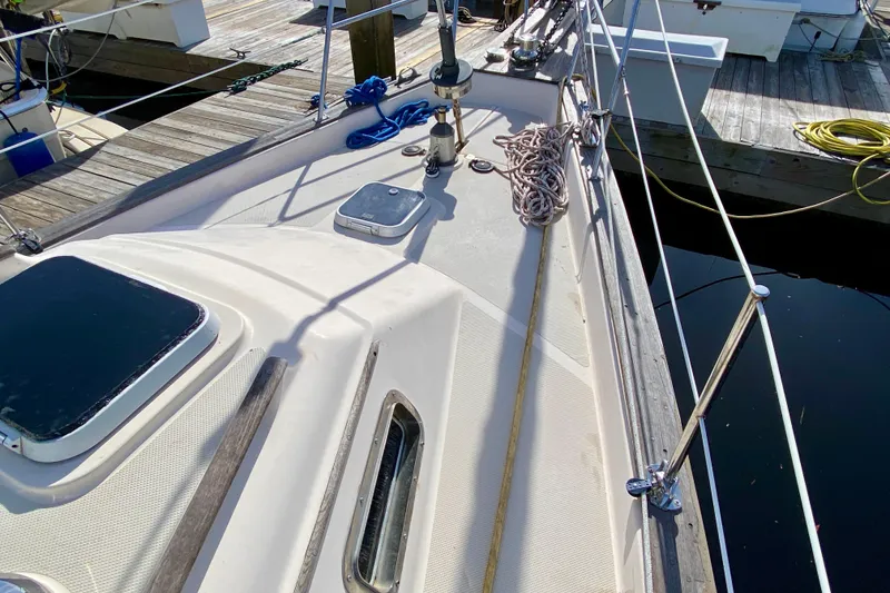 Slide: The Image of Deck view of a 1994 Island Packet 44 sailboat docked at a marina. - 24