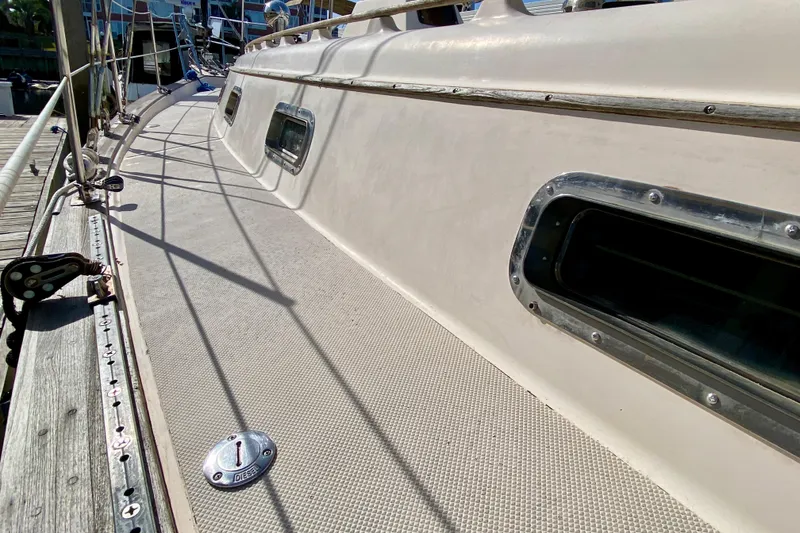 Slide: The Image of Deck view of 1994 Island Packet 44 sailboat, showcasing portholes and diesel cap. - 32