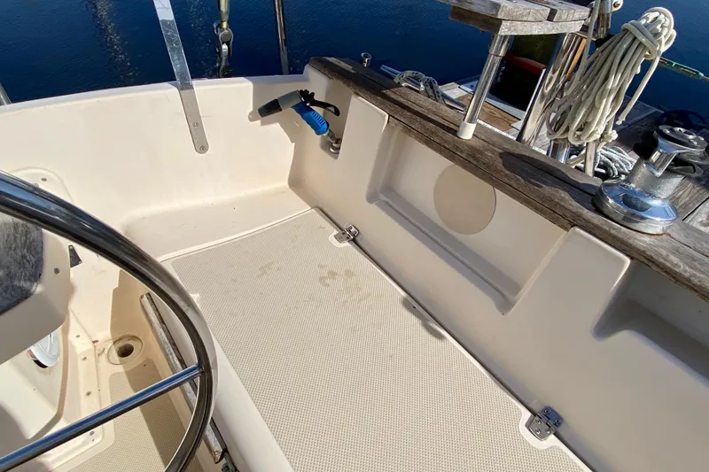 Slide: The Image of Cockpit of 1994 Island Packet 44 sailboat with steering wheel and nautical equipment. - 36