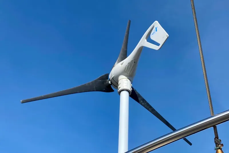 Slide: The Image of Wind turbine on 1994 Island Packet 44 sailboat against clear blue sky. - 38