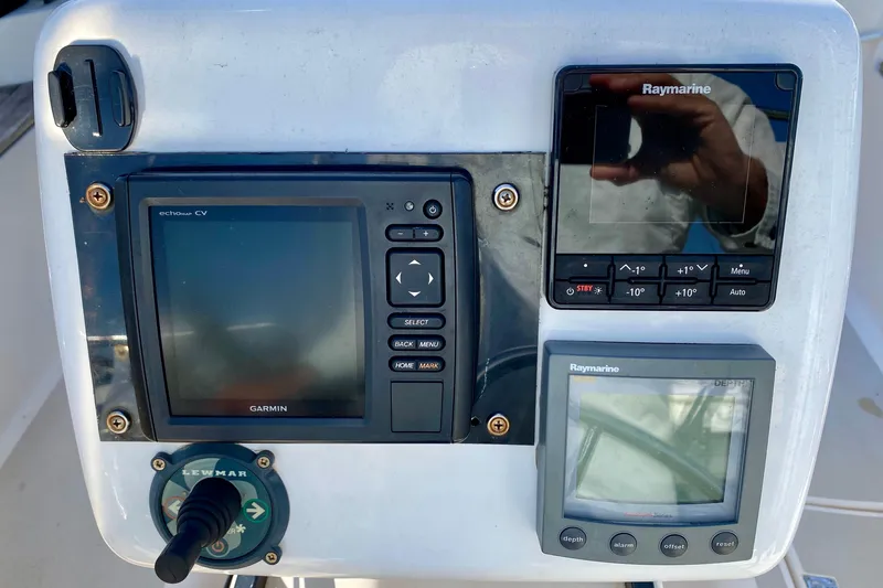 Slide: The Image of Navigation equipment on a 1994 Island Packet 44 sailboat, featuring Garmin and Raymarine displays. - 40
