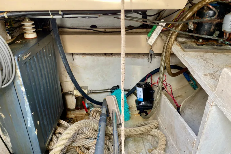 Slide: The Image of Engine compartment of a 1994 Island Packet 44 sailboat with ropes and equipment. - 42