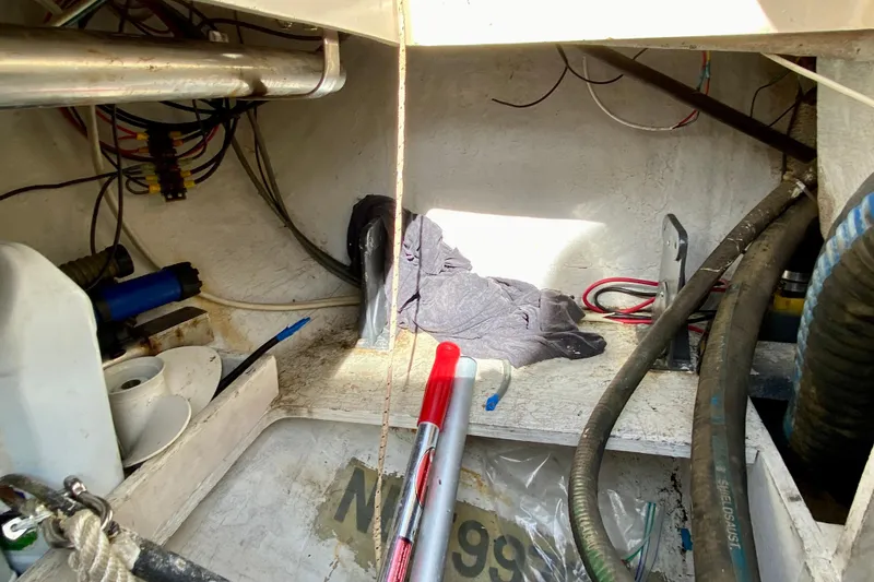 Slide: The Image of Interior view of a 1994 Island Packet 44 sailboat showing storage and wiring. - 43