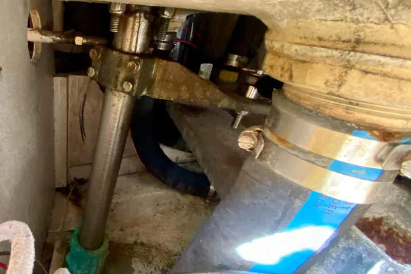 Slide: The Image of Engine compartment of a 1994 Island Packet 44 sailboat, showing mechanical components and fittings. - 50