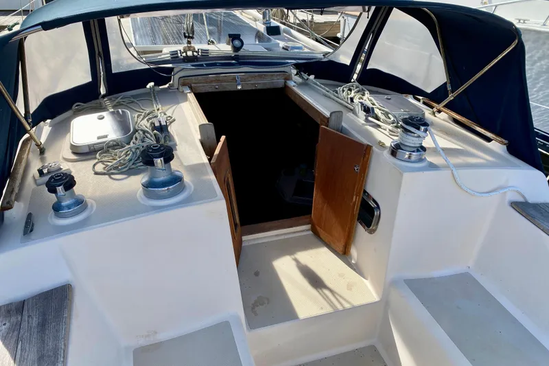 Slide: The Image of Cockpit of 1994 Island Packet 44 sailboat with open companionway and winches. - 53