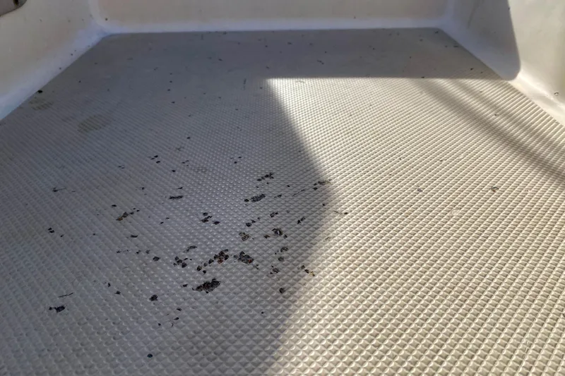 Slide: The Image of Textured deck surface of a 1994 Island Packet 44 sailboat with scattered debris. - 56