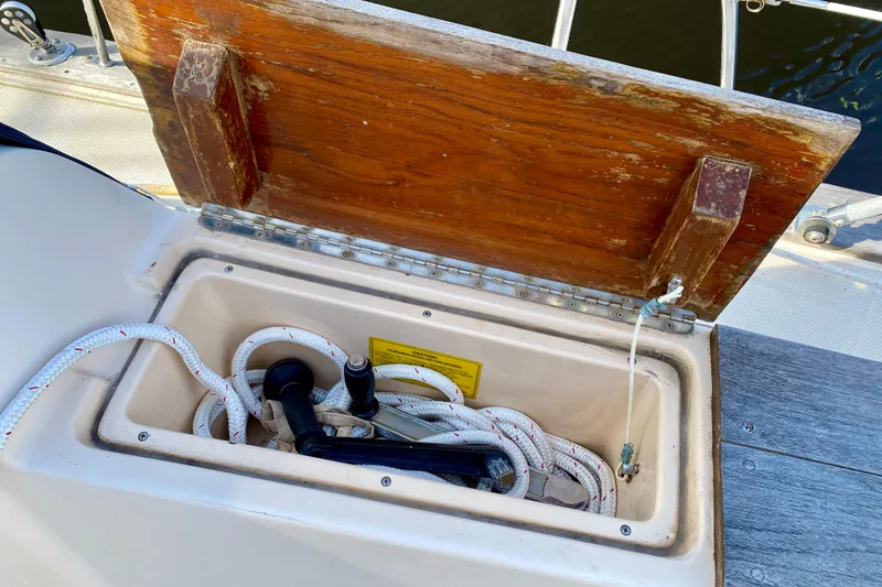 Slide: The Image of Open storage compartment on 1994 Island Packet 44 sailboat, containing ropes and equipment. - 57