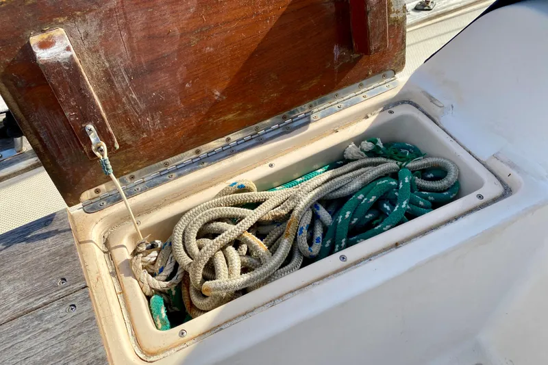 Slide: The Image of Open storage compartment with ropes on a 1994 Island Packet 44 sailboat. - 58