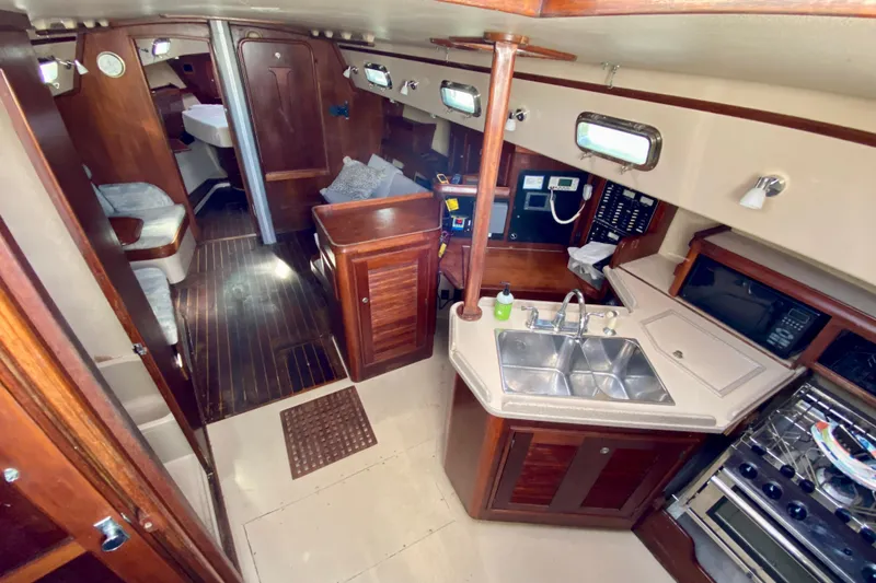 Slide: The Image of Interior of 1994 Island Packet 44 sailboat with kitchen and seating area. - 64