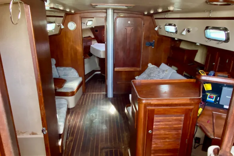Slide: The Image of Interior of 1994 Island Packet 44 sailboat with wooden furnishings and cozy seating. - 66