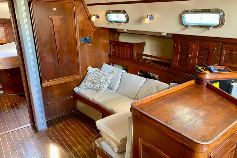 Slide: The Image of Interior of 1994 Island Packet 44 yacht with wooden furnishings and cozy seating area. - 69