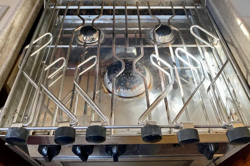 Slide: The Image of Stove with metal grates on a 1994 Island Packet 44 yacht. - 73