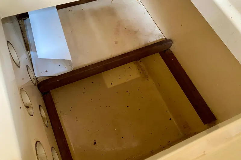 Slide: The Image of Empty storage compartment on a 1994 Island Packet 44 sailboat. - 74