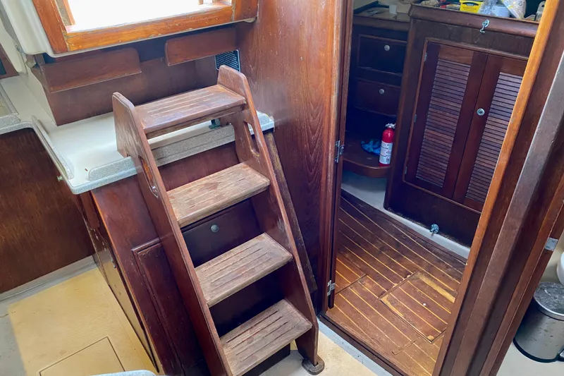 Slide: The Image of Interior of a 1994 Island Packet 44 sailboat with wooden stairs and cabinetry. - 77
