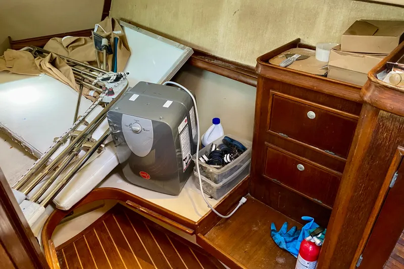 Slide: The Image of Interior of 1994 Island Packet 44 sailboat with storage, heater, and maintenance supplies. - 81