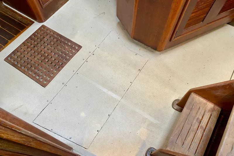 Slide: The Image of Interior flooring of a 1994 Island Packet 44 sailboat with wooden accents. - 83