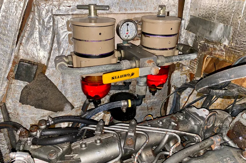 Slide: The Image of Engine room of a 1994 Island Packet 44 sailboat with fuel filters and gauge. - 86