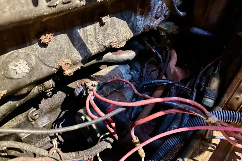 Slide: The Image of Engine compartment of a 1994 Island Packet 44 sailboat with visible wiring and corrosion. - 88