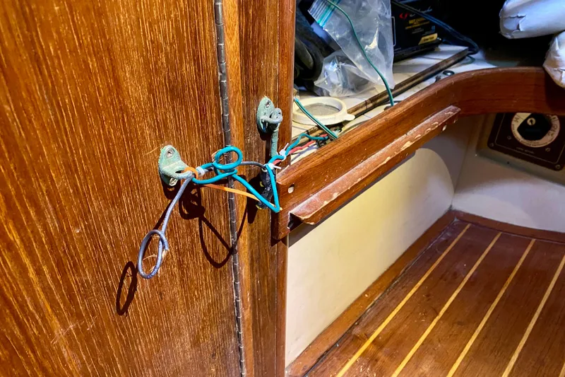 Slide: The Image of Interior of 1994 Island Packet 44 sailboat showing wooden cabinetry and exposed wiring. - 97