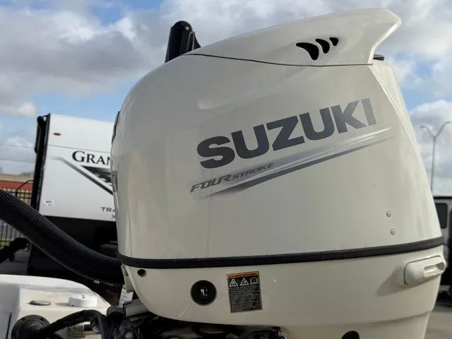 Slide: The Image of Suzuki outboard motor on a 2020 Carolina Skiff 19SWS boat. - 19