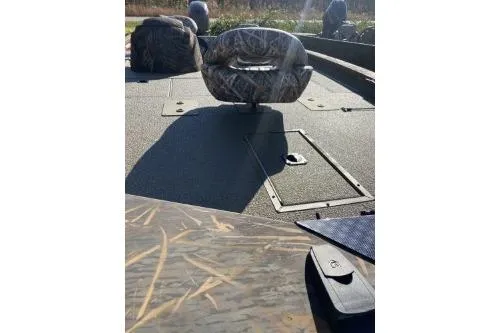 Slide: The Image of 2026 G3 Sportsman 1710 PFX boat interior with camo seating and storage compartments. - 1