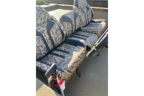 Slide: The Image of 2026 G3 Sportsman 1710 PFX boat seats with camouflage pattern and armrests. - 3