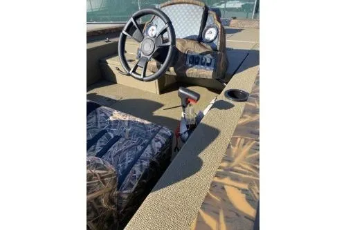 Slide: The Image of 2026 G3 Sportsman 1710 PFX boat interior with steering wheel and camo seating. - 4