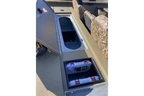 Slide: The Image of 2026 G3 Sportsman 1710 PFX boat storage compartments with camo seating. - 5