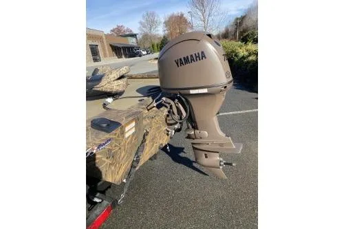Slide: The Image of 2026 G3 Sportsman 1710 PFX boat with Yamaha outboard motor in parking lot. - 6