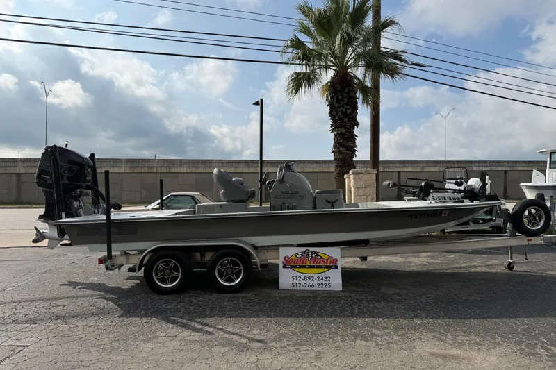 The Image of 2018 SCB Stingray boat on trailer, parked outdoors under cloudy sky. - 0