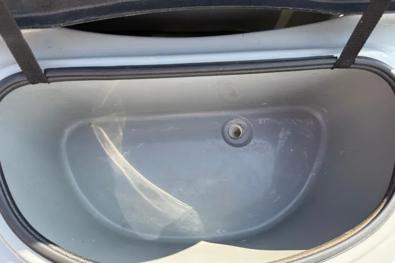 Slide: The Image of Open storage compartment of a 2018 SCB Stingray boat. - 26