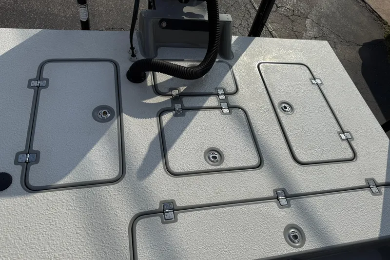 Slide: The Image of 2018 SCB Stingray boat deck with multiple storage compartments and textured surface. - 32