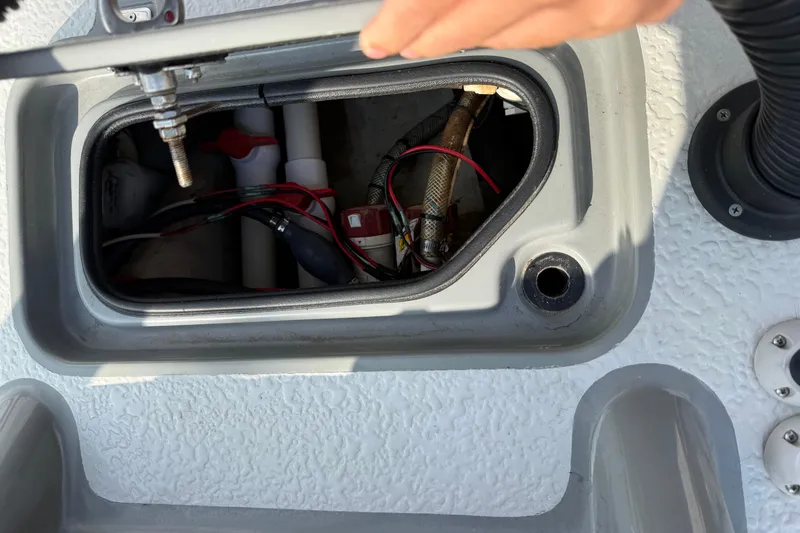 Slide: The Image of 2018 SCB Stingray boat compartment with wiring and plumbing components visible. - 33