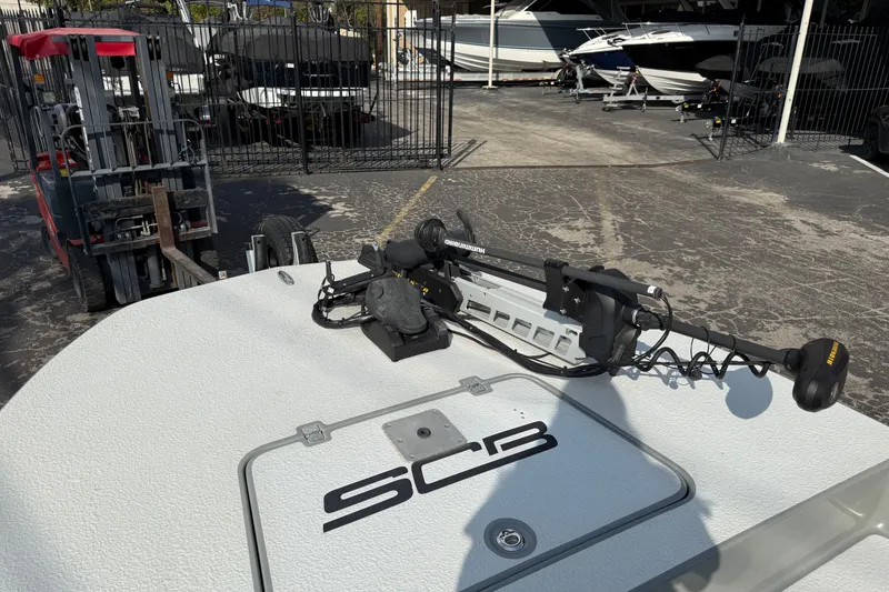 Slide: The Image of 2018 SCB Stingray boat with trolling motor in a marina setting. - 40
