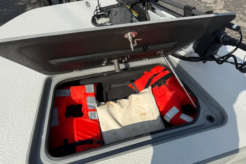Slide: The Image of Open storage compartment on 2018 SCB Stingray boat with life jackets inside. - 41