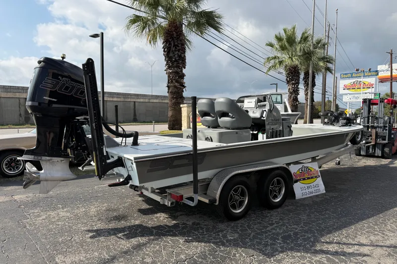Slide: The Image of 2018 SCB Stingray boat with Mercury 300 engine on a trailer, parked outdoors. - 45