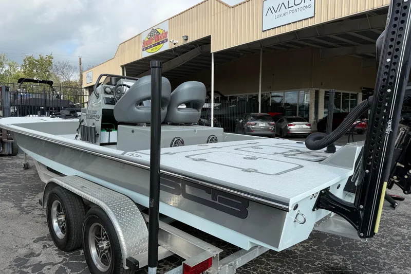 Slide: The Image of 2018 SCB Stingray boat on trailer outside dealership, showcasing sleek design and dual seats. - 5