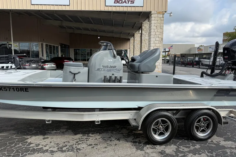 Slide: The Image of 2018 SCB Stingray boat on trailer at dealership, showcasing sleek design and modern features. - 6