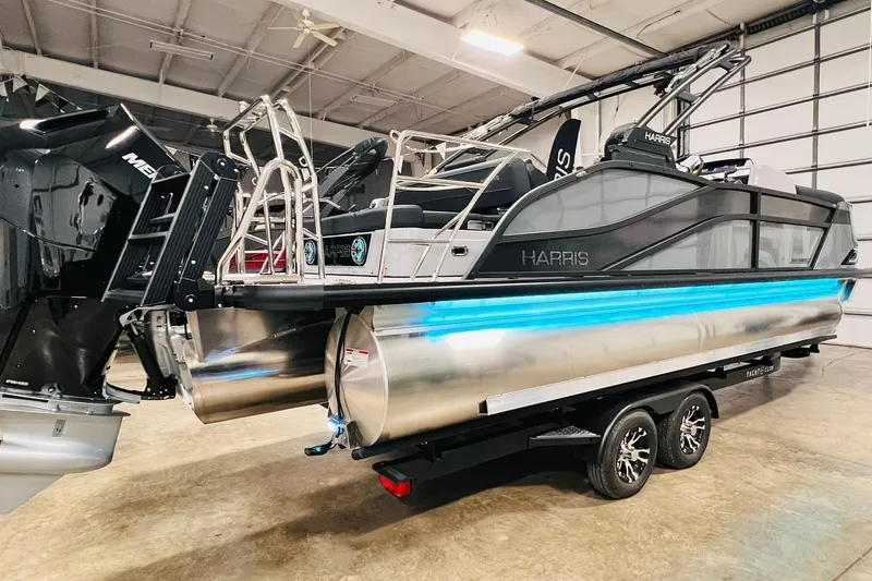 Slide: The Image of 2026 Harris Grand Mariner 230 pontoon boat with sleek design and modern features in a showroom. - 12