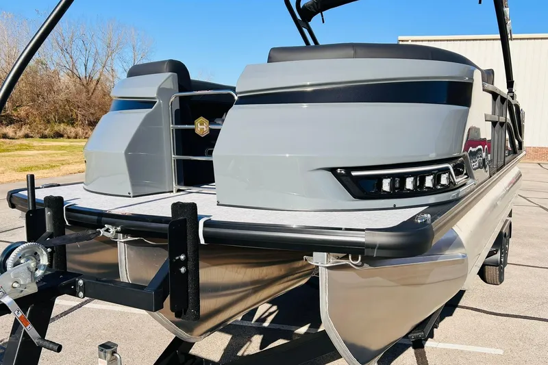 Slide: The Image of 2026 Harris Grand Mariner 230 pontoon boat on trailer, showcasing sleek design and modern features. - 2