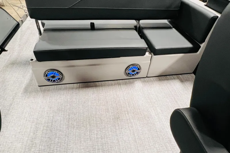 Slide: The Image of 2026 Harris Grand Mariner 230 interior with black seating and blue speakers. - 24