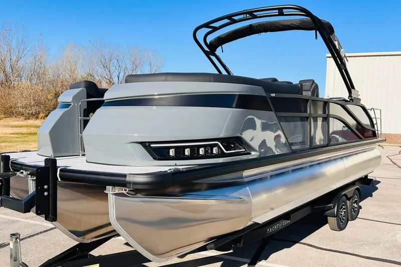 Slide: The Image of 2026 Harris Grand Mariner 230 pontoon boat on trailer, sleek design, outdoor setting. - 3