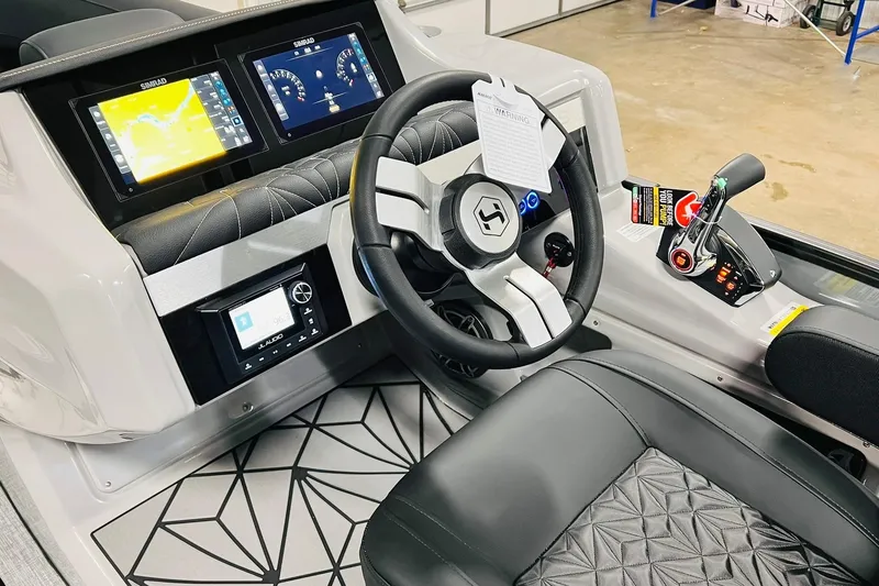 Slide: The Image of 2026 Harris Grand Mariner 230 helm with advanced controls and dual Simrad displays. - 38