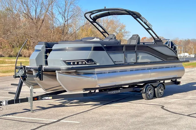 Slide: The Image of 2026 Harris Grand Mariner 230 pontoon boat on trailer in parking lot. - 4