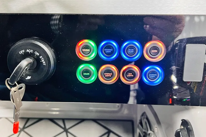 Slide: The Image of Control panel of 2026 Harris Grand Mariner 230 with illuminated buttons and ignition key. - 40