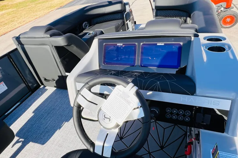 Slide: The Image of 2026 Harris Grand Mariner 230 boat interior with dual screens and modern steering wheel. - 43